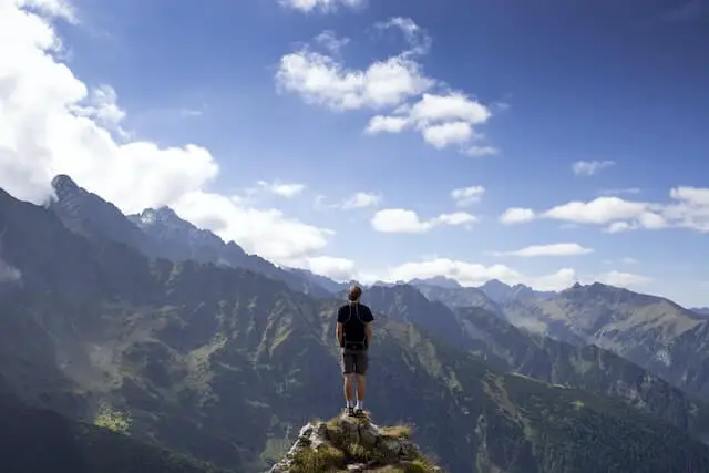a person standing on a mountain hill