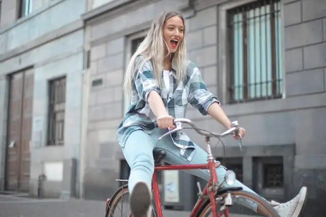 a woman happily riding a bicycle