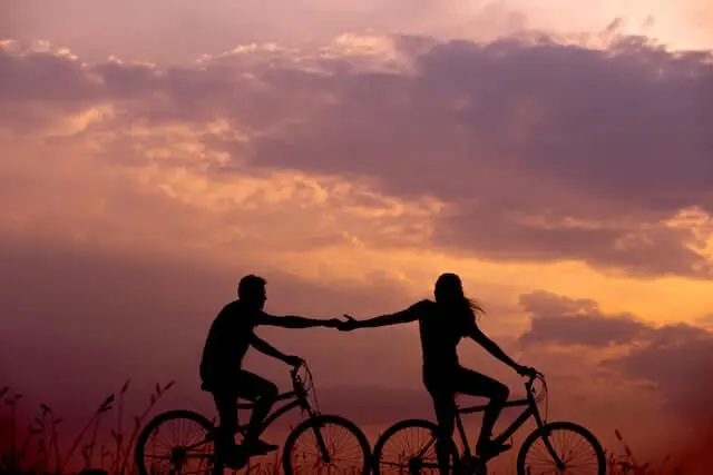 two people on bikes during sunset