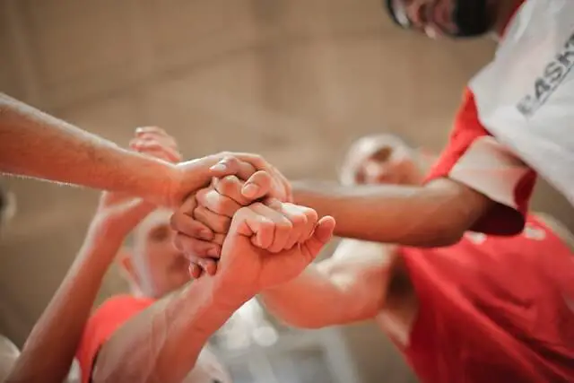 team stacking hands together