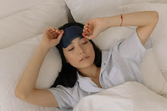 woman in a sleep mask waking up
