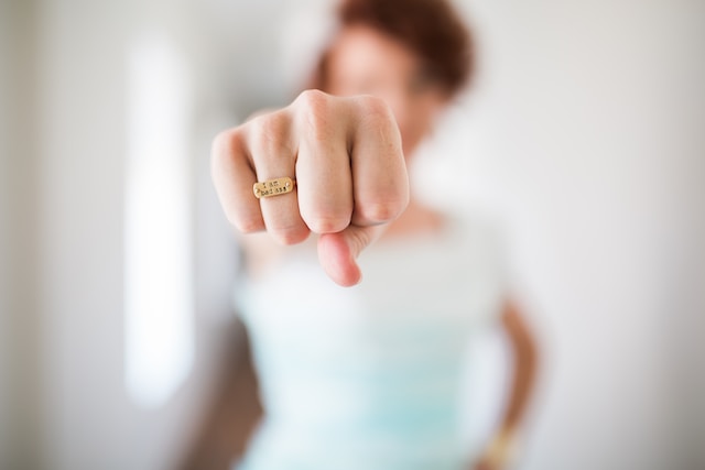 woman showing gold ring on her fist