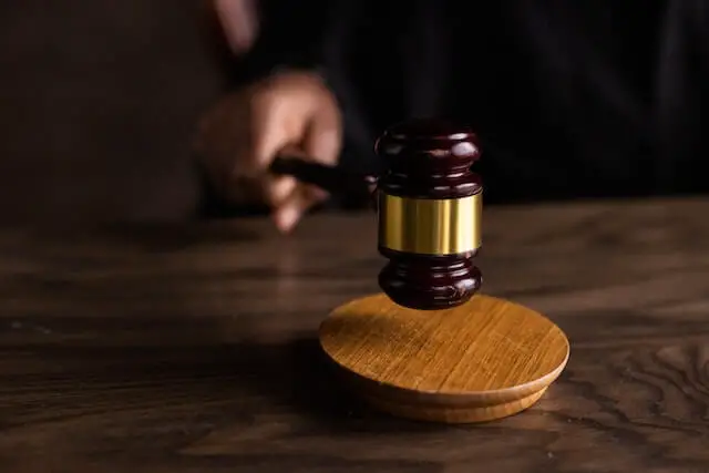 wooden gavel on a brown table